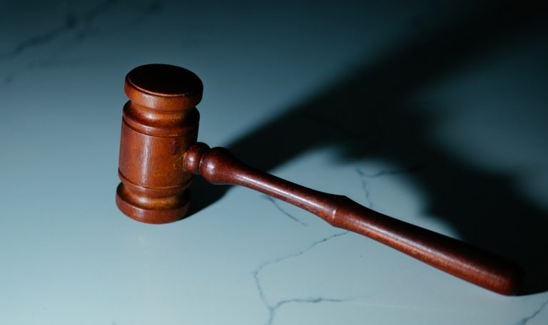 a wooden judge's hammer sitting on top of a table